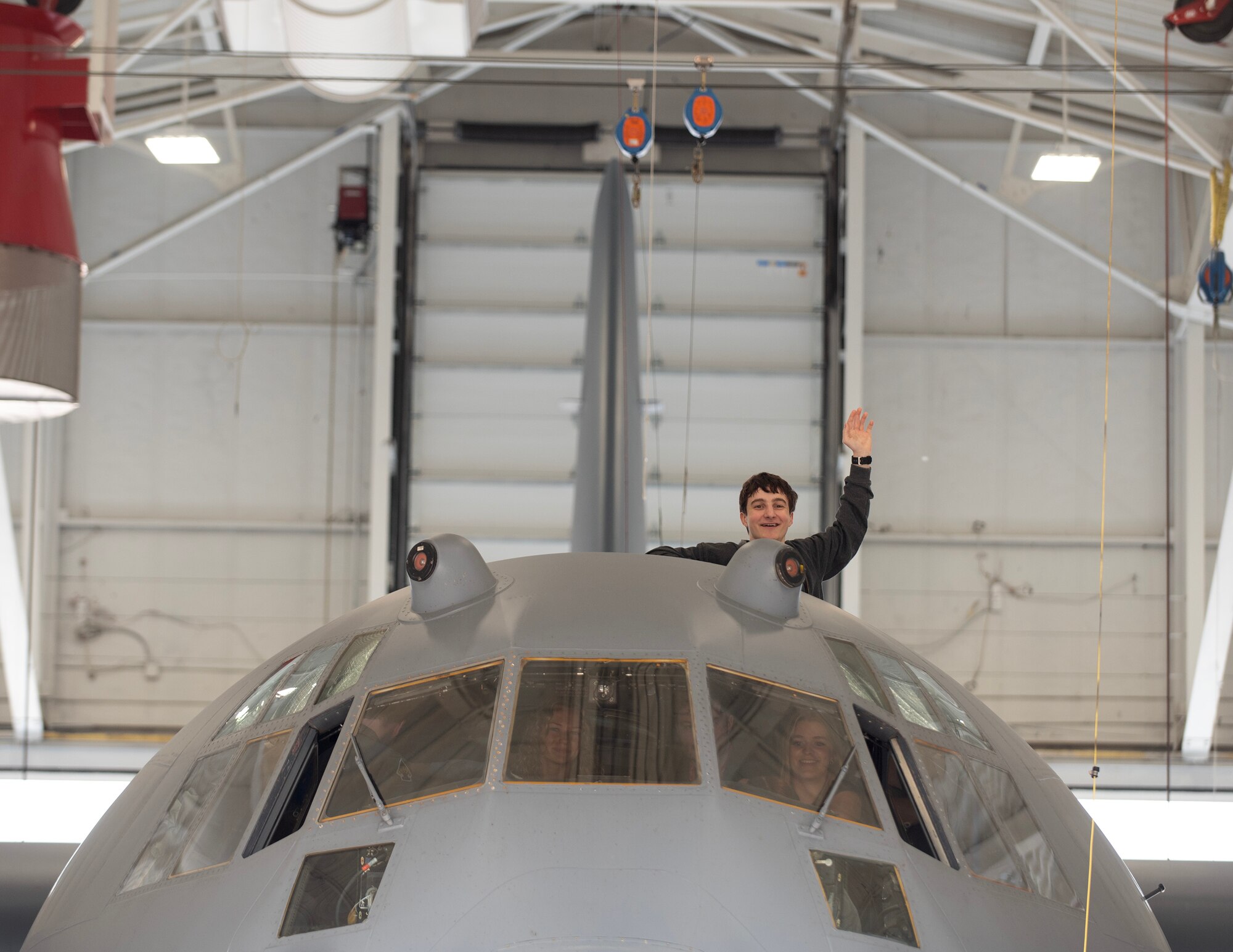 A Minnesota Aviation Career Education Camp participant waves from the top of the C-130 Hercules in St. Paul, Minn., June 15, 2023.
