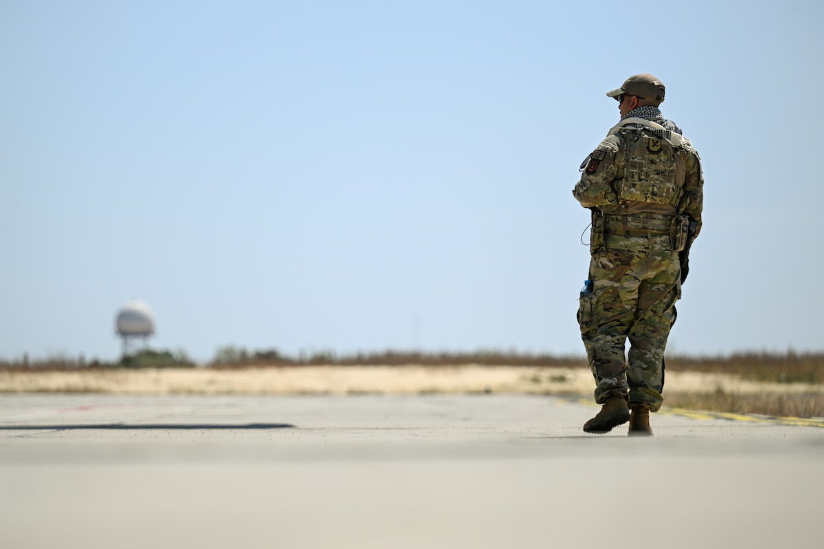 Photo of Airman standing watch over C-17.