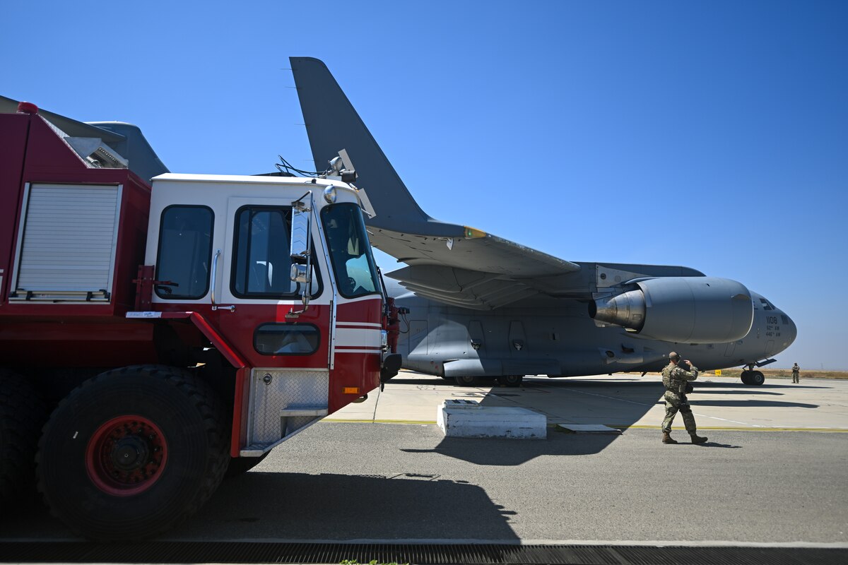 Photo of firetruck alongside aircraft.