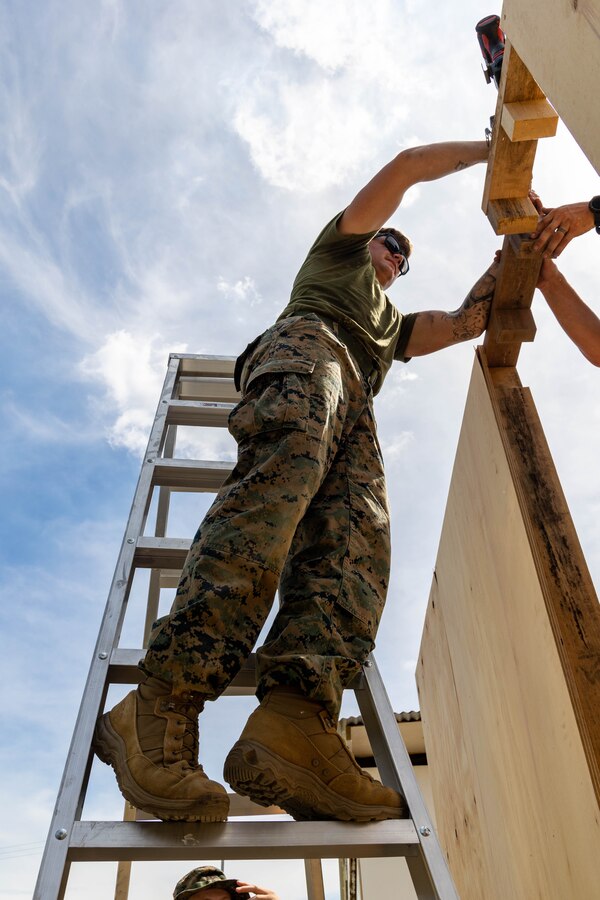 U.S. Marine Corps Sgt. Shane Stoltenberg, a native of Ravenna, Nebraska, and landing support specialist with Task Force Koa Moana 23, builds a door frame for a Southwest Asia (SWA) hut on Goldie River Training Camp, Port Moresby, Papua New Guinea, July 12, 2023. Task Force Koa Moana 23, composed of U.S. Marines and Sailors from I Marine Expeditionary Force, deployed to the Indo-Pacific to strengthen relationships with Pacific Island partners through bilateral and multilateral security cooperation and community engagements. (U.S. Marine Corps photo by Staff Sgt. Courtney G. White)