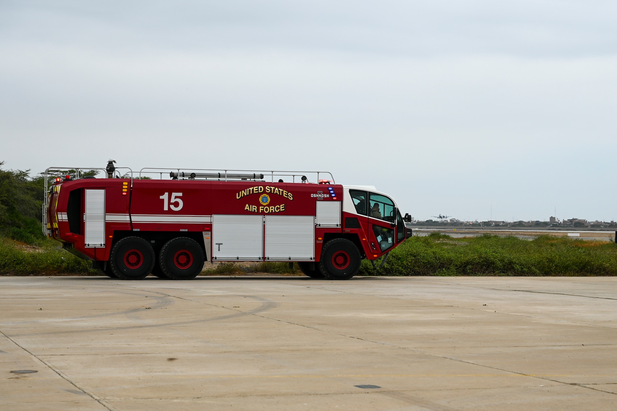 A fire truck sits on the flightline on fire watch as the first-ever A-10 launched from South America lifts off July 11, 2023, at Chiclayo, Peru. The A-10s are deployed from Davis-Monthan Air Force Base, Ariz., as part of Patriot Fury, the first Air Force Reserve-led international exercise in South America focusing on agile combat employment and the new Air Force Force Gerneration model. (U.S. Air Force photo by Master Sgt. Bob Jennings)