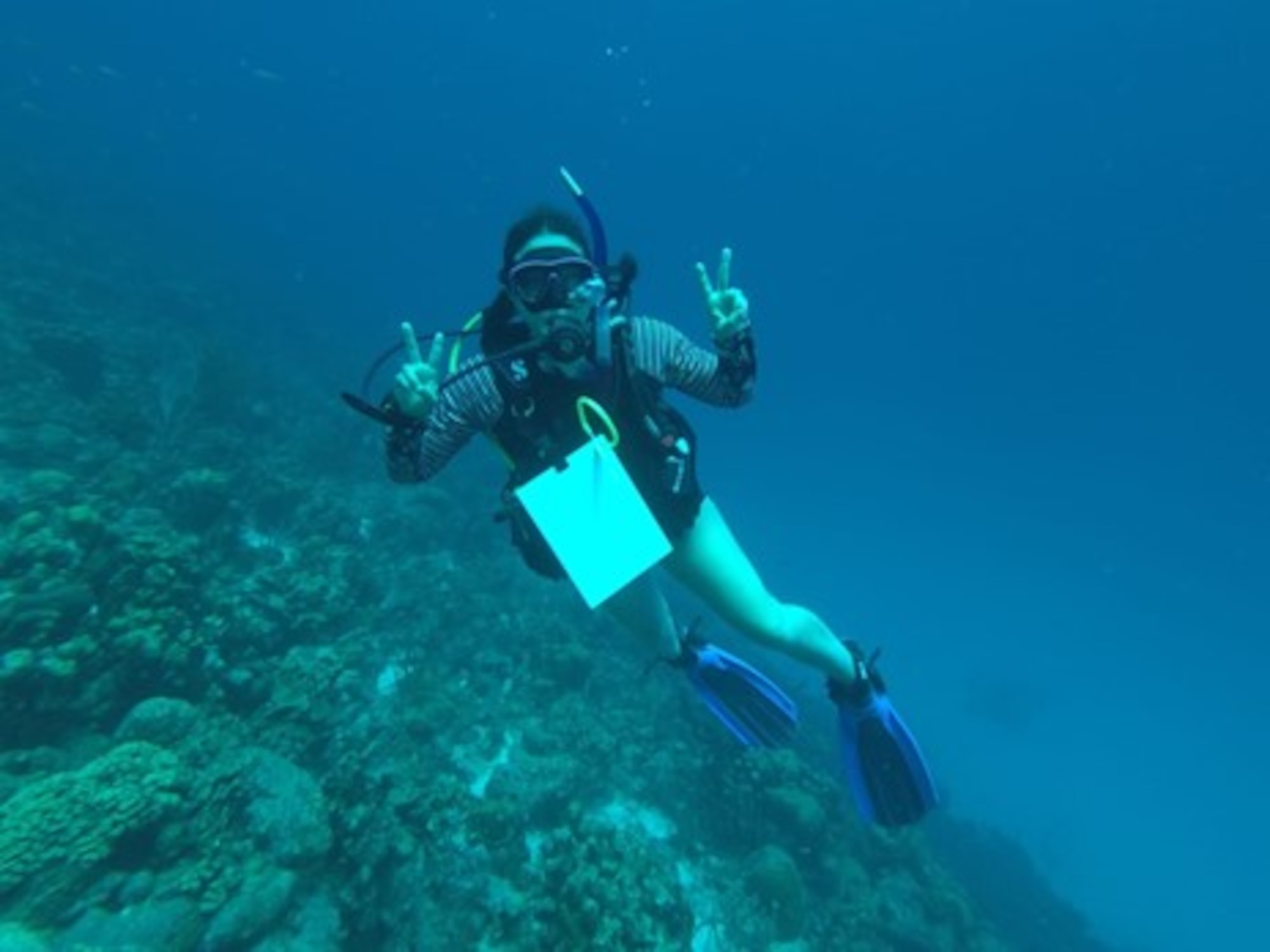 U.S. Air Force Maj. Lindsay Cordero, Air Force Global Strike Command Commander’s Action Group legislative liaison officer, poses for a photo with her sketching slate while scuba diving around the Karpata Reef in Bonaire, Netherlands Antilles, on June 23, 2022. Cordero’s mission is to bring feelings of joy and belonging through her art and writing, which focuses on children’s literacy, conservation, and mental health. (U.S. Air Force courtesy photo)