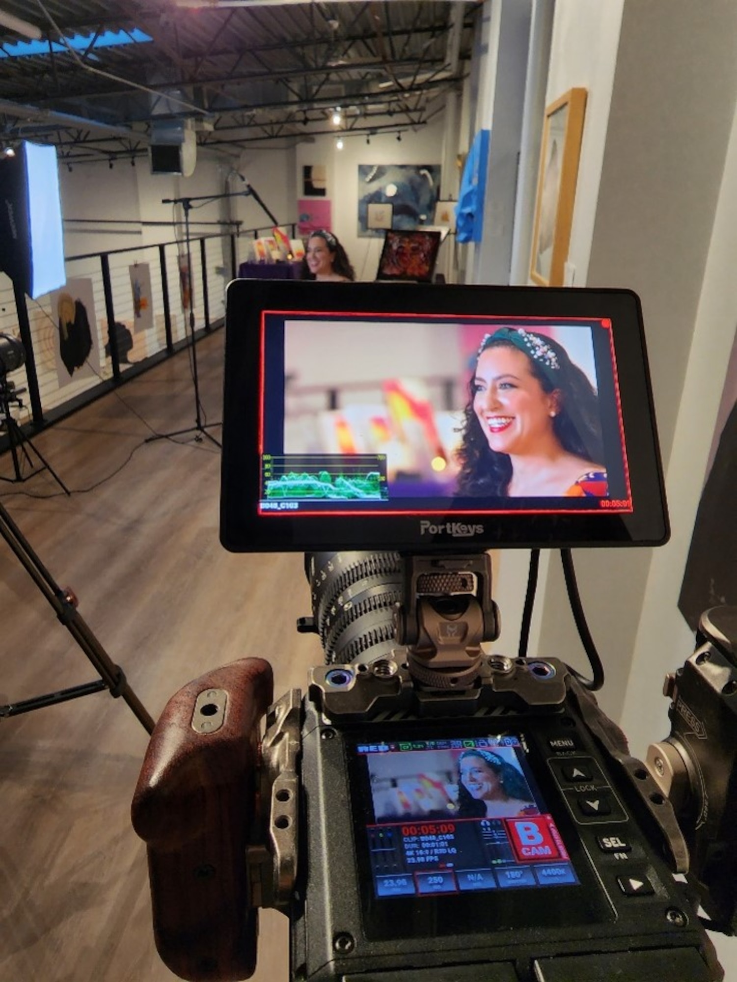 U.S. Air Force Maj. Lindsay Cordero, Air Force Global Strike Command Commander’s Action Group legislative liaison officer, is filmed for her episode of Artisan Air, at her art gallery exhibition in Austin, Texas, on November 9, 2022. The Air Force Service Center’s newest season of Artisan Air features 30-minute episodes, with Cordero’s episode focusing on her mission of bringing feelings of joy and belonging through her art and writing, which focuses on children’s literacy, conservation, and mental health. (U.S. Air Force courtesy photo)