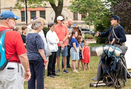 Don McArthur-Self, a Civil War reenactor with the 8th Illinois Cavalry, talks about equipment Soldiers would use during the Civil War during the First Shot at Gettysburg commemoration July 1 at the DuPage County Historical Museum.