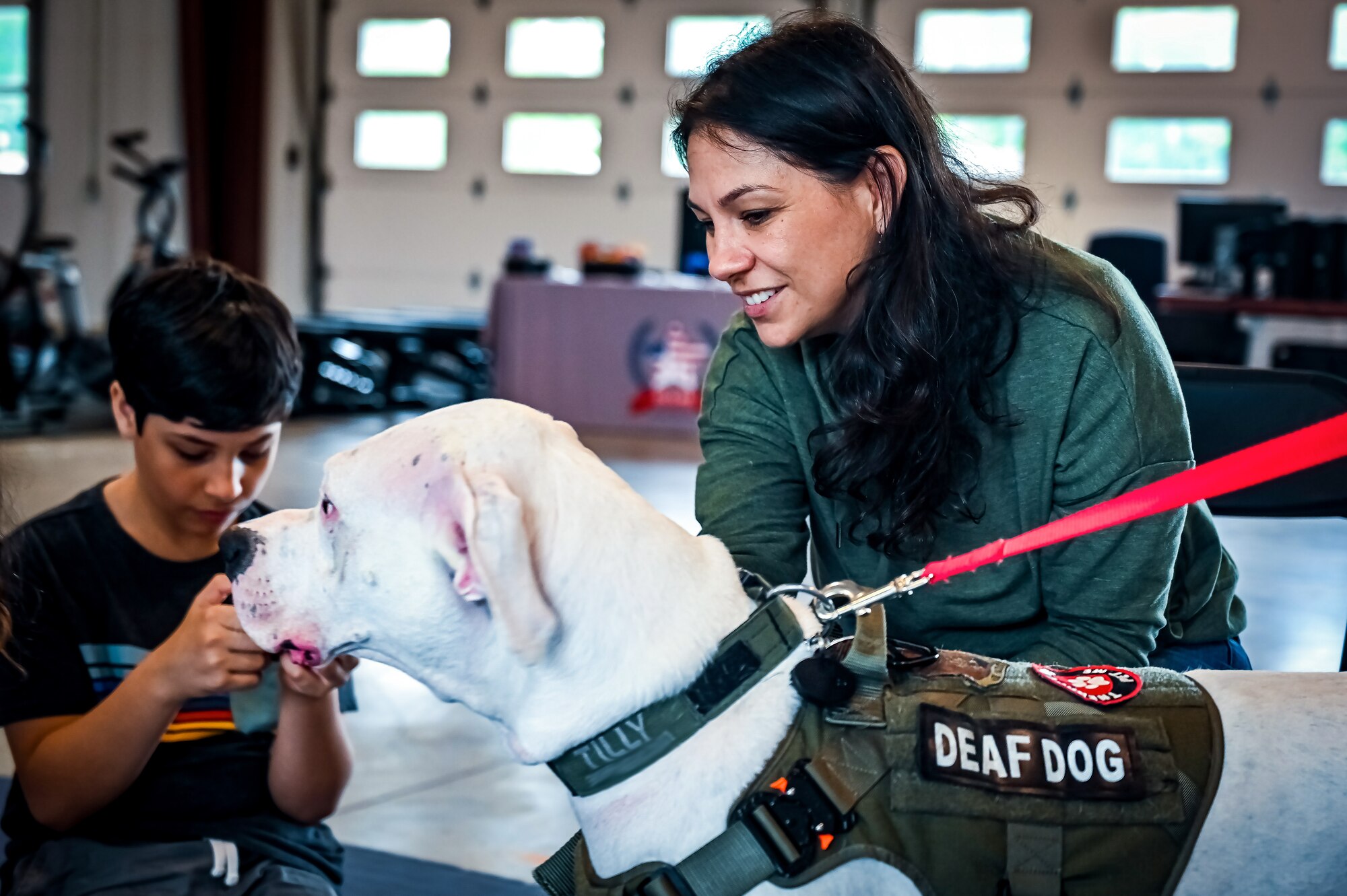 Service members, their families, and volunteers with the Bright and Beautiful Therapy Dogs organization interact with K-9s during a visit to Joint Base McGuire-Dix-Lakehurst, N.J. on 23 June, 2023. Bright and Beautiful Therapy Dogs is a non-profit organization that trains, evaluates and qualifies dogs and their handlers to become certified therapy dog teams. Once certified, teams may visit nursing homes, assisted living facilities, homeless shelters, schools, libraries, universities, mental health facilities, and more. The visit was a first for the Joint Base, where support for Comprehensive Airman Fitness and the resiliency factor across the Joint Force remains a top-line priority for leadership.