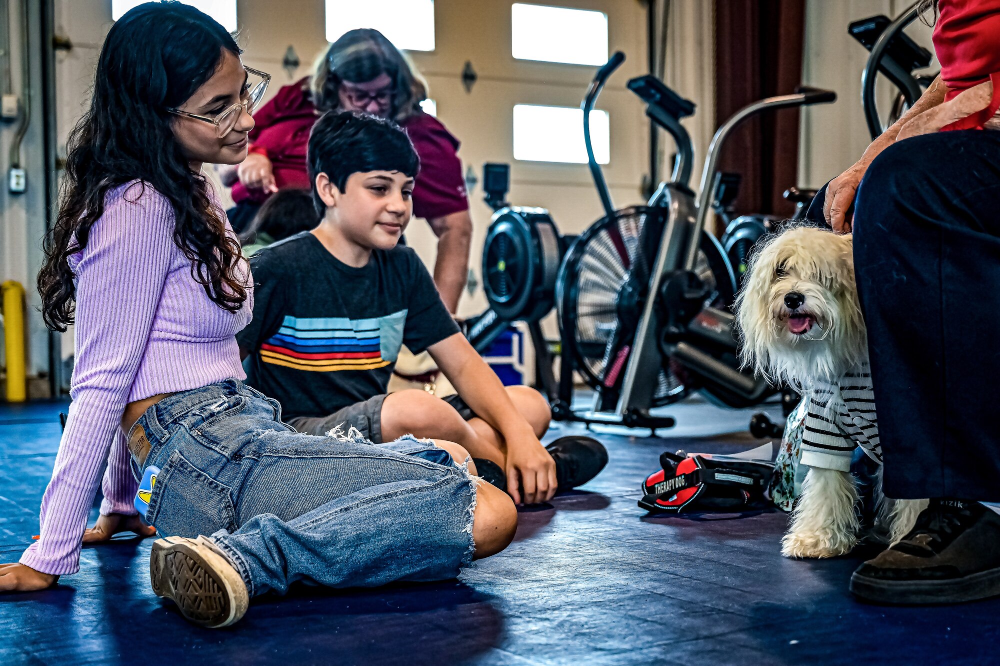 Service members, their families, and volunteers with the Bright and Beautiful Therapy Dogs organization interact with K-9s during a visit to Joint Base McGuire-Dix-Lakehurst, N.J. on 23 June, 2023. Bright and Beautiful Therapy Dogs is a non-profit organization that trains, evaluates and qualifies dogs and their handlers to become certified therapy dog teams. Once certified, teams may visit nursing homes, assisted living facilities, homeless shelters, schools, libraries, universities, mental health facilities, and more. The visit was a first for the Joint Base, where support for Comprehensive Airman Fitness and the resiliency factor across the Joint Force remains a top-line priority for leadership.