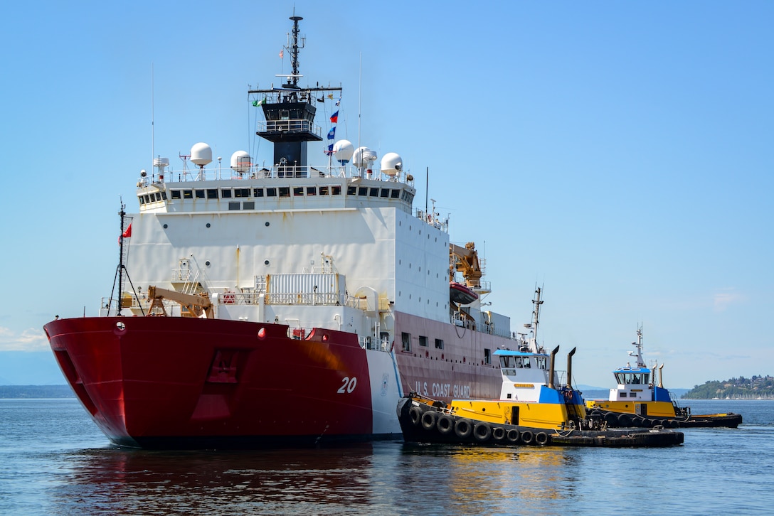 U.S. Coast Guard Cutter Healy (WAGB 20) is assisted by two tugboats as it departs Seattle, July 11, 2023. The cutter is slated to embark upon a several-month mission that will take the crew to the high Arctic latitudes. (U.S. Coast Guard photo by Petty Officer Steve Strohmaier)