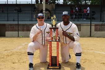 (June 23, 2023) NAVAL STATION NORFOLK, Va.  -- Center for Naval Aviation Technical Training Unit (CNATTU) Norfolk Instructors Aviation Electrician’s Mate 2nd Class Adam Burnett and Aviation Ordnanceman 1st Class Deonte Anderson pose with the trophy after participating as members of the Naval Air Station Airmen softball team during the “Navy World Series Throwback Softball Game” at McClure Stadium June 23. (U.S. Navy photo)