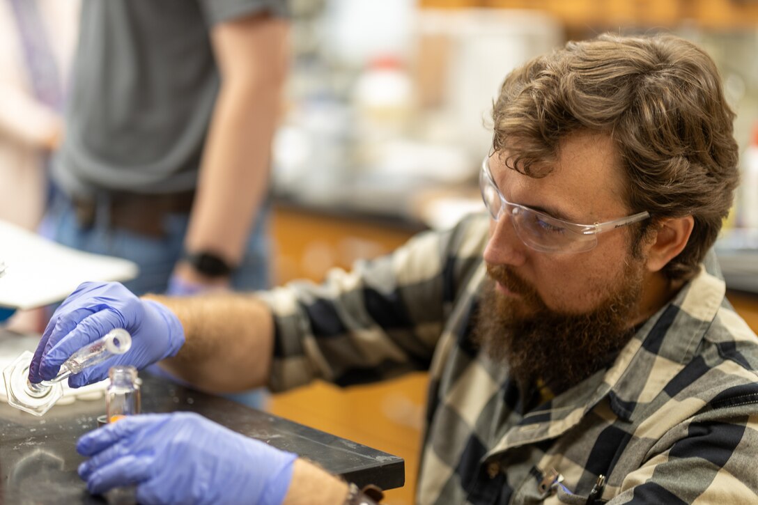 Mark Burgos, a RESET Teacher Program participant and eighth-grade robotics teacher at Vicksburg’s Academy of Innovation, carefully tests chemicals for one of his laboratory projects.