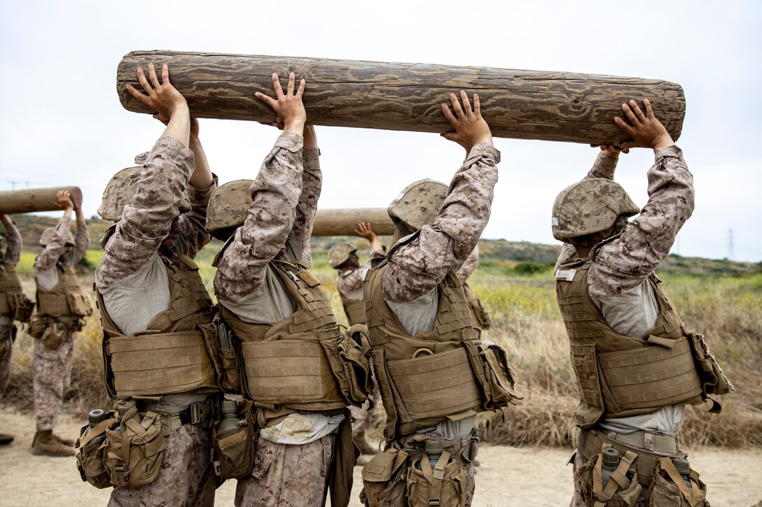 U.S. Marine Corps recruits with Mike Company, 3rd Recruit Training Battalion, execute log drills during the Crucible on Marine Corps Base Camp Pendleton, Calif., July 10, 2023. The Crucible is a 54-hour exercise where recruits apply the knowledge they have learned throughout recruit training, to earn the title of United States Marines. (U.S. Marine Corps photo by Sgt. Guyette)