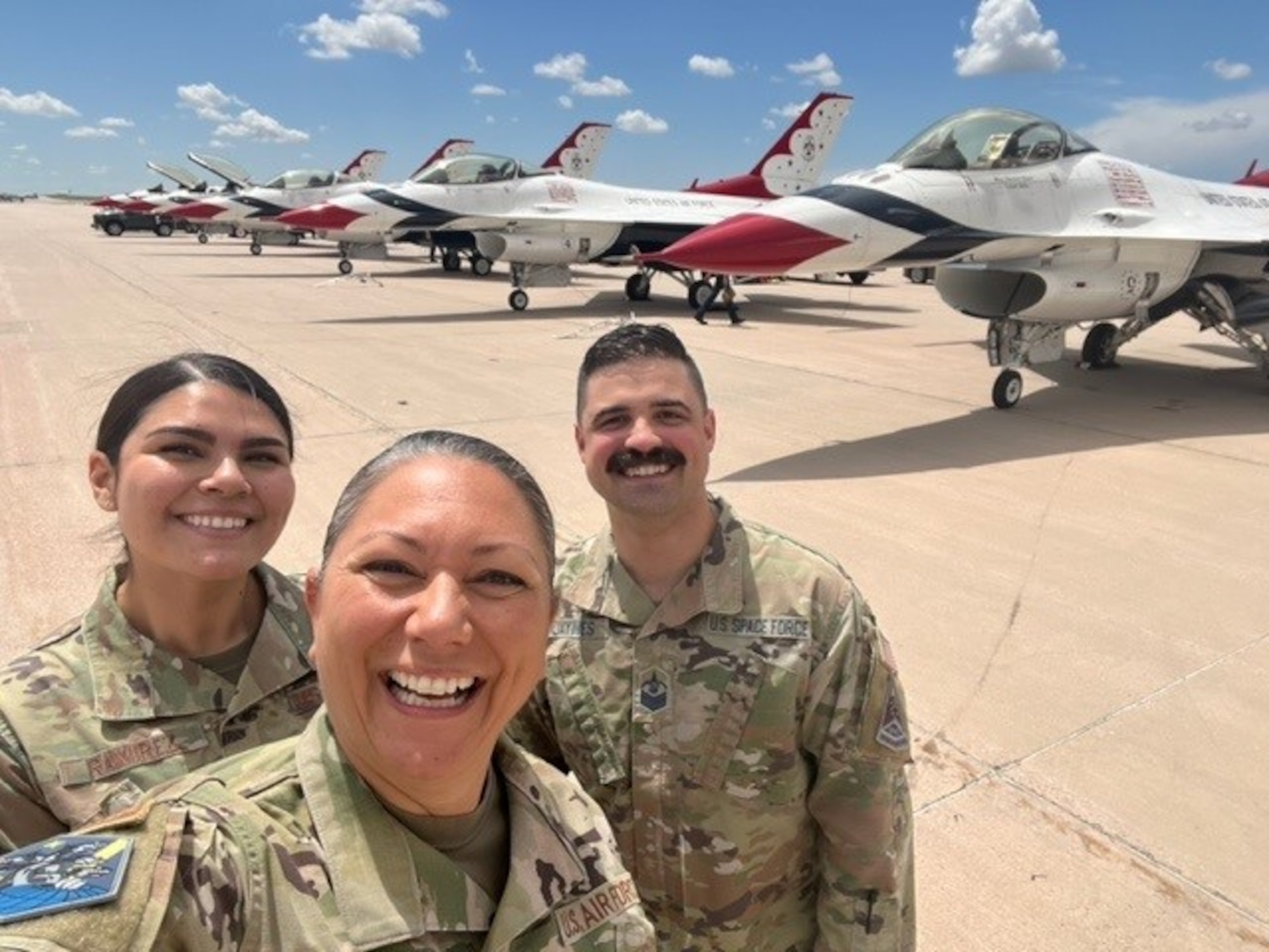 Chief Master Sgt. Sevin Balkuvvar poses for photo with fellow teammates next to U.S. Air Force Thunderbirds aircraft.