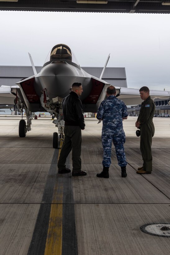 U.S. Marine Corps Lt. Col. Michael O’Brien, Commanding Officer of Marine Fighter Attack Squadron (VMFA) 314, Marine Aircraft Group 11, 3rd Marine Aircraft Wing, discusses the capabilities of a U.S. Marine Corps F-35C Lightning II aircraft with Air Commodore Peter Robinson, Commander of Air Combat Group, Royal Australian Air Force (RAAF), and Wing Commander Adrian Kiely, Commanding Officer of RAAF No. 3 Squadron, while touring RAAF Base Williamtown, New South Wales, Australia, June 28, 2023. The tour allowed for U.S. Marine Corps and Australian military leadership to view on-going unit-level and bilateral training events designed to enhance U.S.-Australian relationships and further develop and sustain capabilities in the Indo-Pacific Region. O’Brien is a Harrisburg, Pennsylvania native. (U.S. Marine Corps photo by Sgt. Joshua Brittenham)