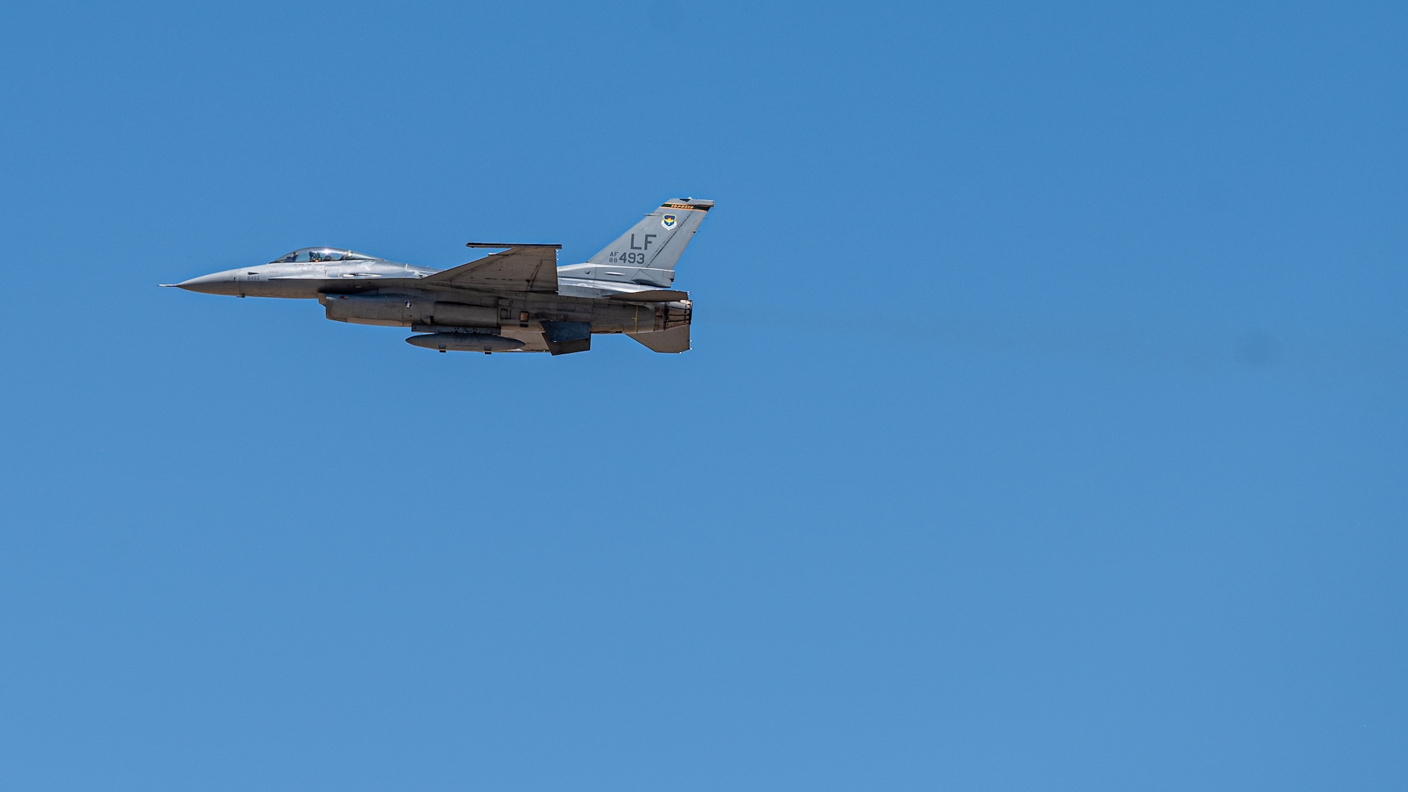 An F-16 Fighting Falcons assigned to the 56th Fighter Wing soars at Luke Air Force Base, Arizona on July 10, 2023.