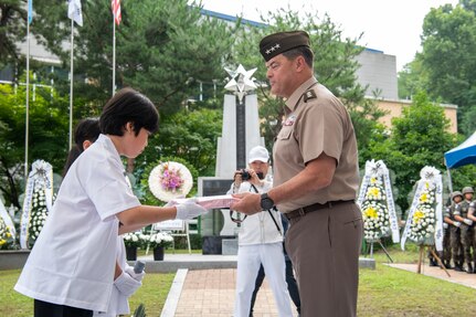 U.S. Army Lt. Gen. Willard M. Burleson III, the Eighth Army commanding general, right, receives thank you letters from a Republic of Korea citizen during the Battle of Cheonan Commemoration Ceremony held at Martin Park in Cheonan City, July 8. The Battle of Cheonan marked the third engagement between U.S. and North Korean forces during the Korean War and took place July 7-8, 1950. The ceremony is in honor of U.S. Army Col. Robert R. Martin, the namesake of the park, who along with 108 U.S. Soldiers from the 34th Infantry Regiment perished in the battle. (U.S. Army photo by Spc. Kianna Scott)