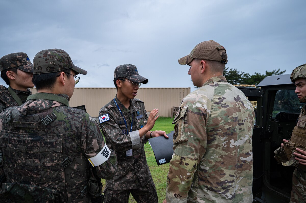 A Republic of Korea Air Force military policeman from the 38th Fighter Group explains procedures to participants of a bilateral training event at Kunsan Air Base