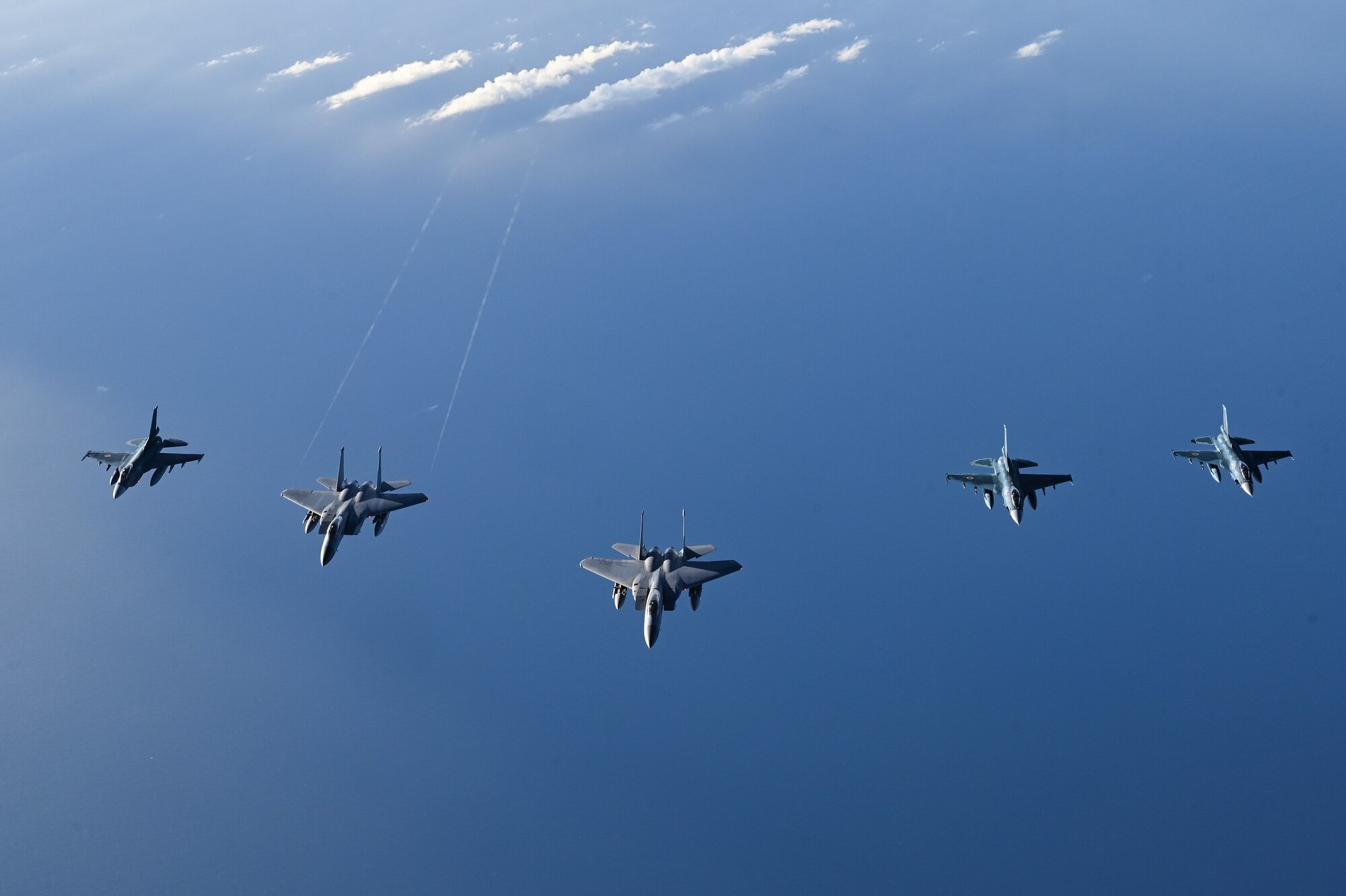 USAF and JASDF aircraft fly in formation.