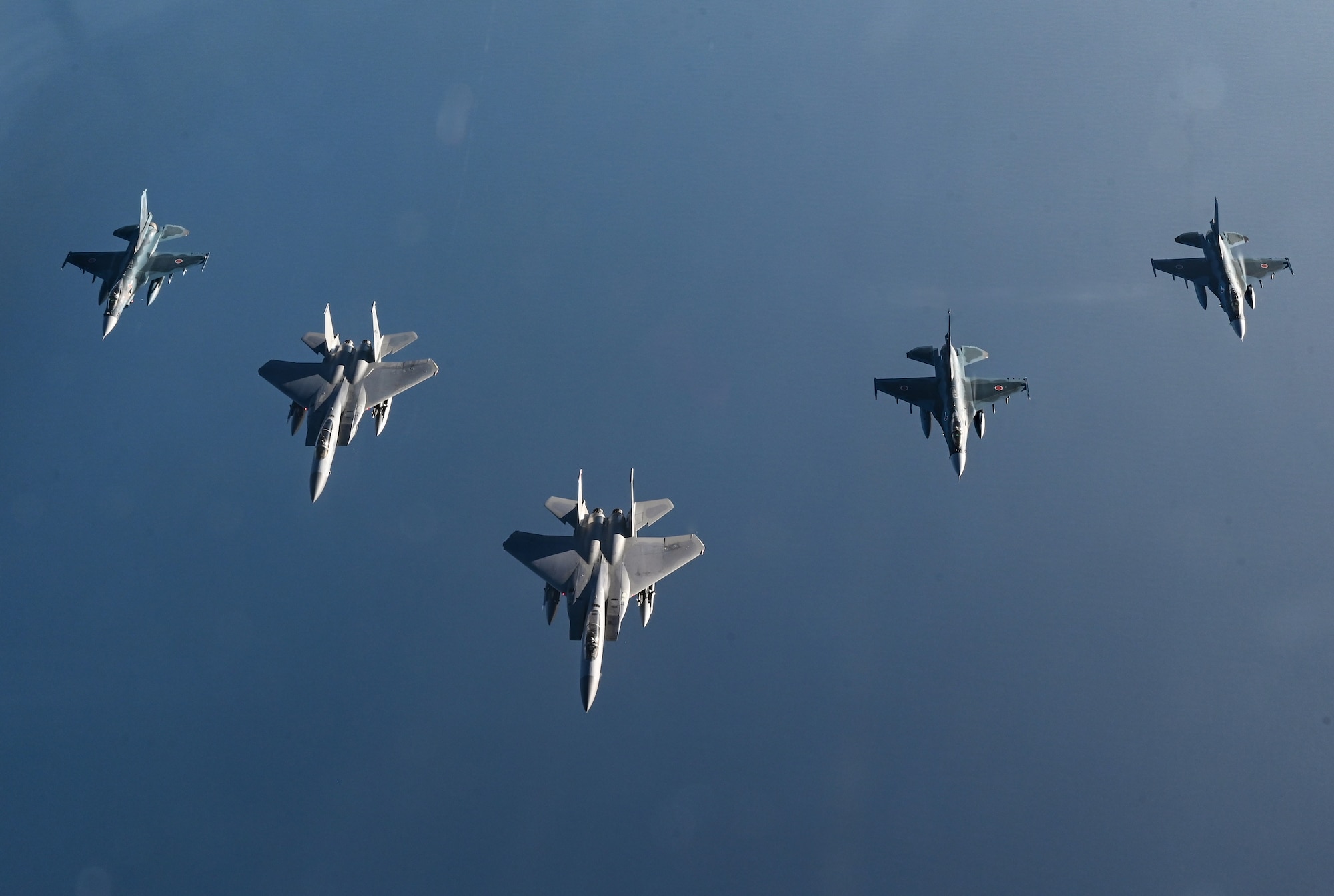 USAF and JASDF aircraft fly in formation.