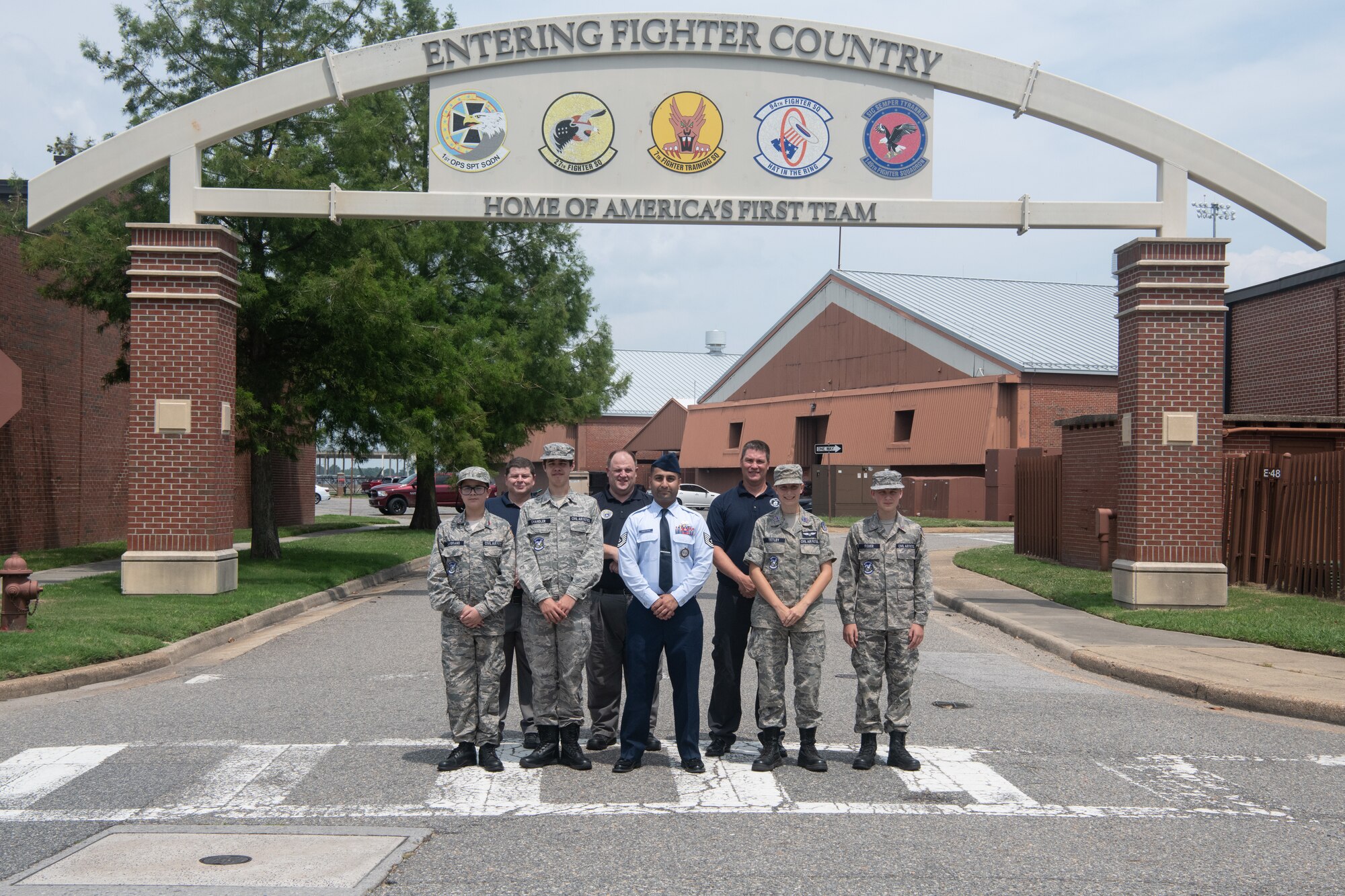 Seven cadets and one VaANG recruiter pose for a group photo.