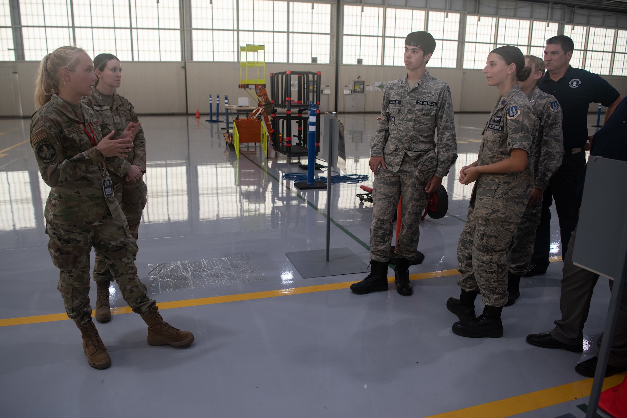 Cadets and Airmen are standing around talking.