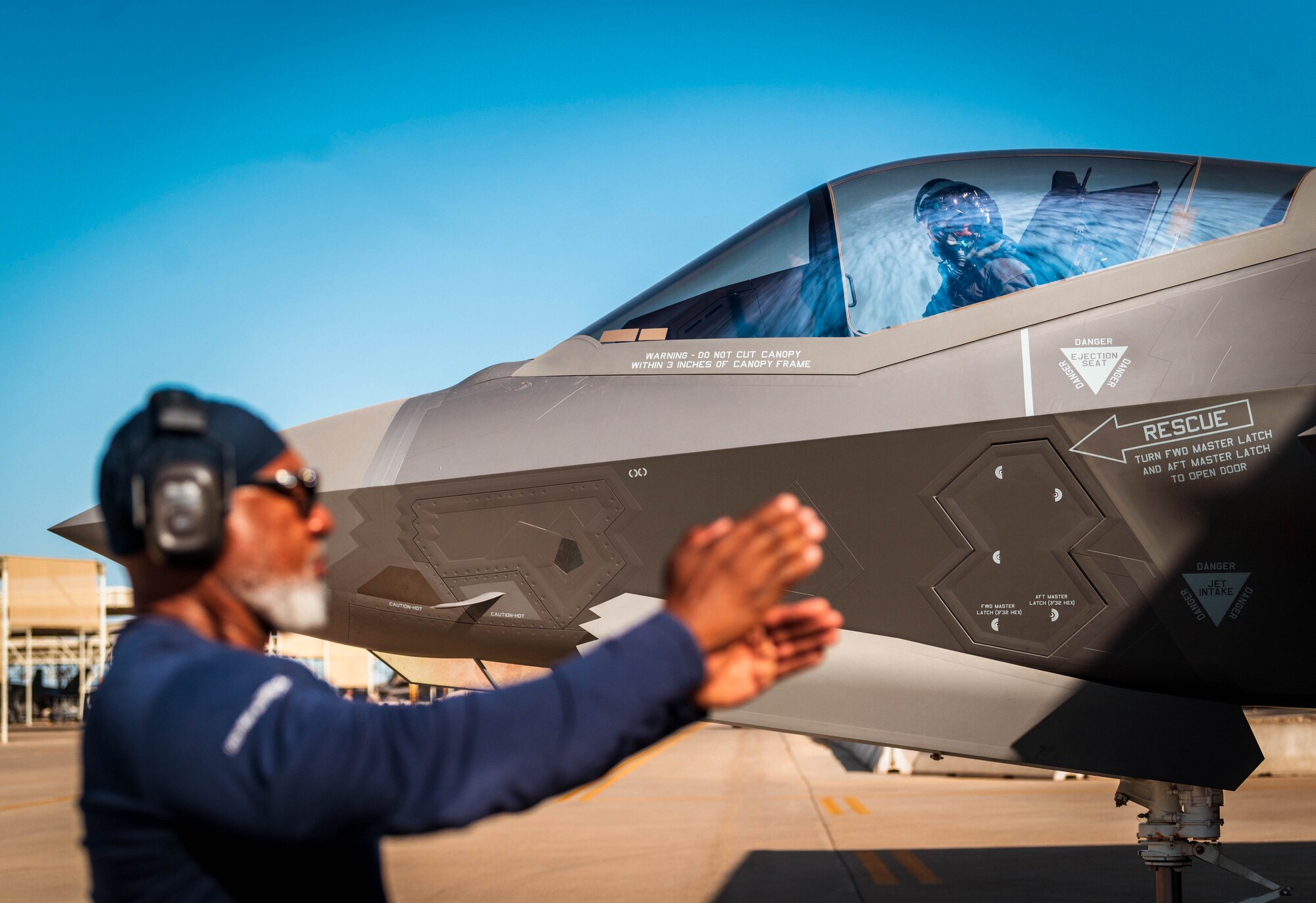 U.S. Air Force Lt. Col. Richard Peace, 187th Operations Support Squadron commander, looks to his crew chief Alden Beatty, 308th Fighter Squadron aircraft mechanic, as he prepares to takeoff in an F-35 Lightning II