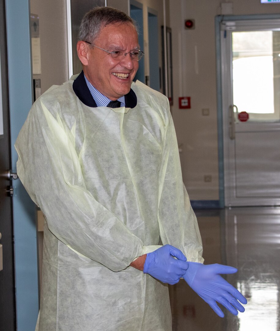 The Honorable Dr. Lester Martinez-Lopez, Assistant Secretary of Defense for Health Affairs (ASD for Health Affairs), dons protective equipment during a visit to Landstuhl Regional Medical Center (LRMC), as part of a larger visit to Europe, July 10, 2023. (U.S. Army Photo by William Beach)