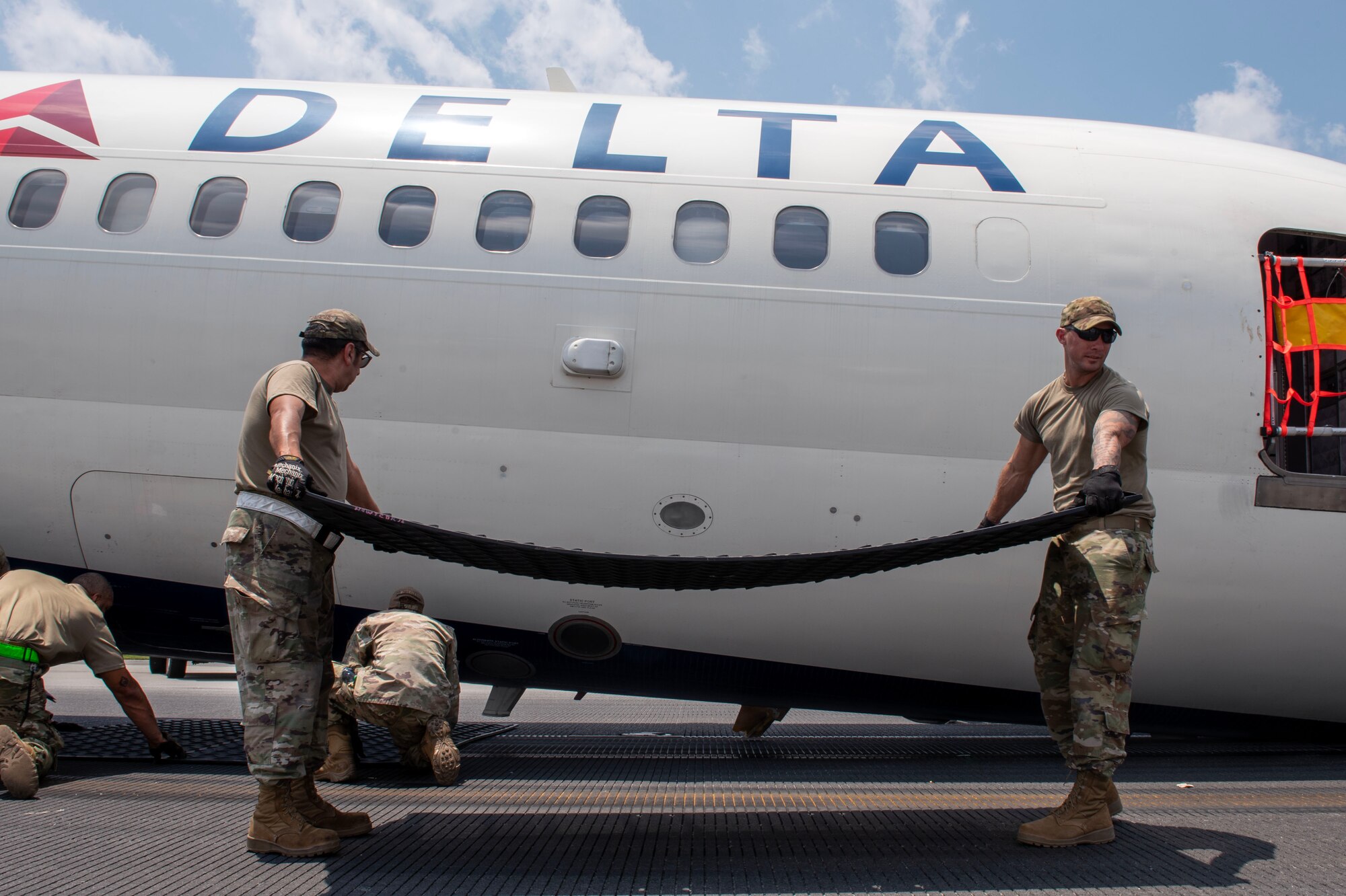 North Carolina Air National Guard assists with aircraft lift due to Delta Airlines flight 1092 making an emergency landing on the Charlotte-Douglas International Airport’s runway June28.