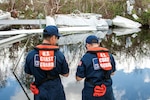 Coast Guard Strike team members Petty Officer 2nd Class C.J. Marsh and Petty Officer 1st Class Tina Kimball assess vessels damaged in Hurricane Ian for potential pollution threats, Fort Myers, Florida, Nov. 1, 2022. Coast Guard environmental response teams are deployed to southwest Florida and working closely with interagency partners to identify and mitigate environmental hazards after the storm. (Coast Guard photo by Petty Officer 1st Class Lisa Ferdinando)