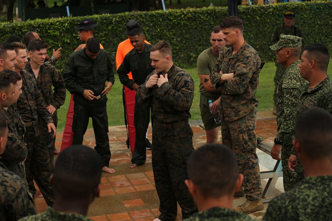 U.S. Marine Corps Cpl. Ellis Holland with 23rd Marine Regiment, 4th Marine Division, demonstrates a flotation technique in a water survival course during exercise UNITAS LXIV, aboard Escuela de Formación de Infantería Marina Coveñas in Coveñas, Colombia, July 12, 2023. UNITAS is the world’s longest-running maritime exercise. Hosted this year by Colombia, it brings together multinational forces from 20 partner nations, including 26 warships/vessels, three submarines, 25 aircraft (fixed wing/helicopter) and approximately 7,000 people. The exercise trains forces in joint maritime operations that enhance tactical proficiency and increase interoperability with the presence of unmanned air, surface, and submarine systems. (U.S. Marine Corps photo by Sgt. Emily Kirk)