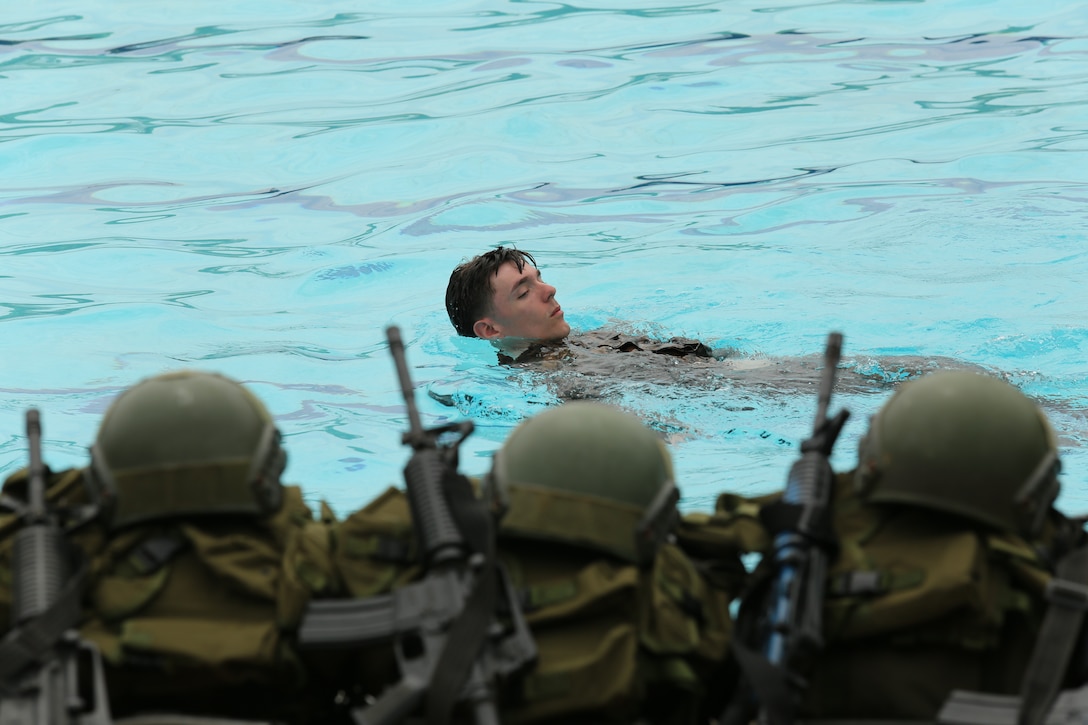 U.S. Marine Corps Cpl. Pacey Lenge with 23rd Marine Regiment, 4th Marine Division, swims across a pool in a water survival course during exercise UNITAS LXIV, aboard Escuela de Formación de Infantería Marina Coveñas in Coveñas, Colombia, July 12, 2023. UNITAS, taking place in Colombia this year, is the world’s longest-running annual multinational maritime exercise that focuses on enhancing interoperability among multiple nations and joint forces during littoral and amphibious operations in order to build on existing regional partnerships and create new enduring relationships that promote peace, stability, and prosperity in the U.S. Southern Command’s area of responsibility. (U.S. Marine Corps photo by Sgt. Emily Kirk)