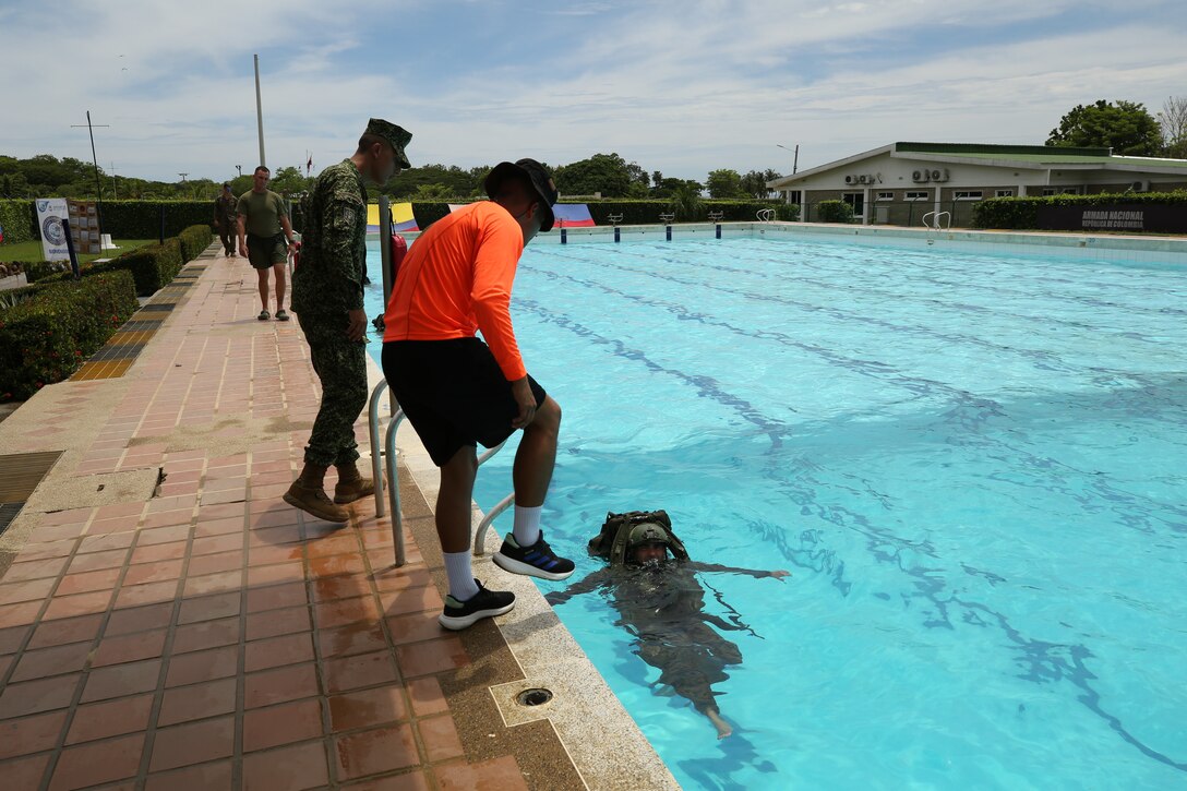 Colombian Naval Infantry Marines evaluate swimming techniques in a water survival course during exercise UNITAS LXIV, aboard Escuela de Formación de Infantería Marina Coveñas in Coveñas, Colombia, July 12, 2023. UNITAS, taking place in Colombia this year, is the world’s longest-running annual multinational maritime exercise that focuses on enhancing interoperability among multiple nations and joint forces during littoral and amphibious operations in order to build on existing regional partnerships and create new enduring relationships that promote peace, stability, and prosperity in the U.S. Southern Command’s area of responsibility. (U.S. Marine Corps photo by Sgt. Emily Kirk)