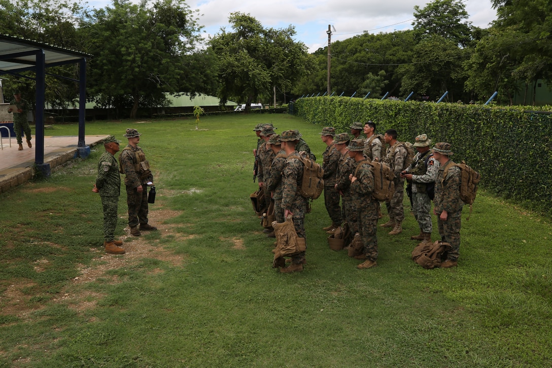 U.S. Marines with 23rd Marine Regiment, 4th Marine Division, in support of Special Purpose Marine Air-Ground Task Force UNITAS LXIV, and partner nation militaries, receive instruction from the Colombian Naval Infantry, in a water survival course during exercise UNITAS LXIV, aboard Escuela de Formación de Infantería Marina Coveñas in Coveñas, Colombia, July 12, 2023. UNITAS is the world’s longest-running maritime exercise. Hosted this year by Colombia, it brings together multinational forces from 20 partner nations, including 26 warships/vessels, three submarines, 25 aircraft (fixed wing/helicopter) and approximately 7,000 people. The exercise trains forces in joint maritime operations that enhance tactical proficiency and increase interoperability with the presence of unmanned air, surface, and submarine systems. (U.S. Marine Corps photo by Sgt. Emily Kirk)