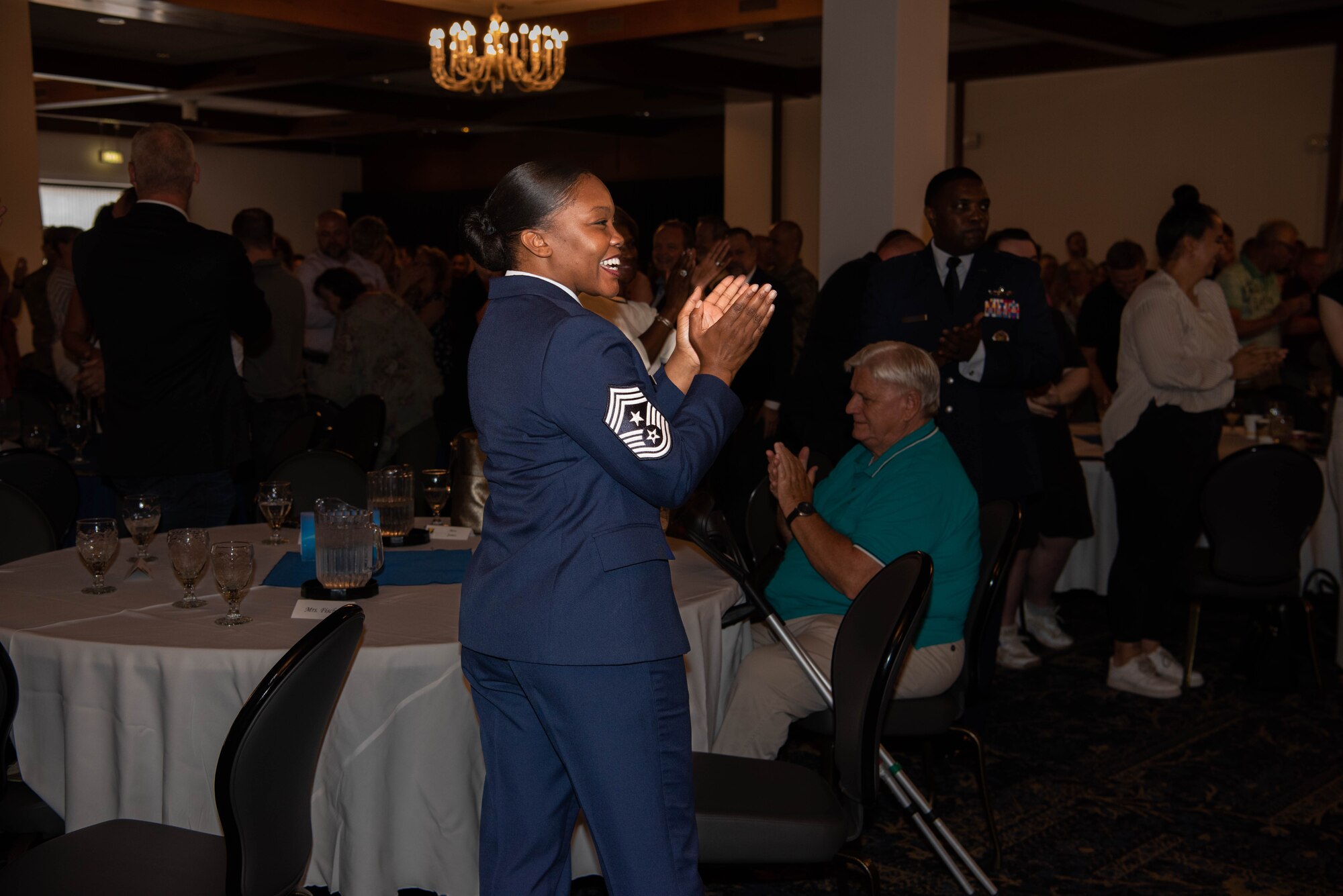 U.S. Air Force Chief Master Sgt. Charmaine Kelley, 86th Airlift Wing command chief, claps during the Length of Service ceremony at Ramstein Air Base, Germany, July 13, 2023.