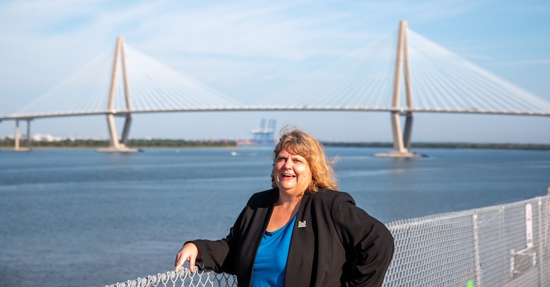 Lisa Metheney poses for a photo with the Ravenel Bridge in the background
