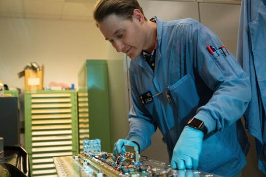  WASHINGTON (March 4, 2022) – Zachary Kaldy, U.S. Naval Research Laboratory thermal engineer, inspects the Space Wireless Energy Laser Link (SWELL) in Washington, D.C. April 3, 2022. SWELL will launch aboard the DoD Space Test Program-H9 payload (STP-H9) to the International Space Station in 2023, where it will then be powered on and operate for one to two years. SWELL will be the first on-orbit demonstrations of Laser Power Beaming. (U.S. Navy photo by Jonathan Sunderman)