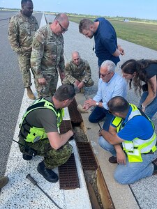 Members of the 235th Civil Engineering Flight and their partners analyze the runway at Amari Air Base, Estonia.