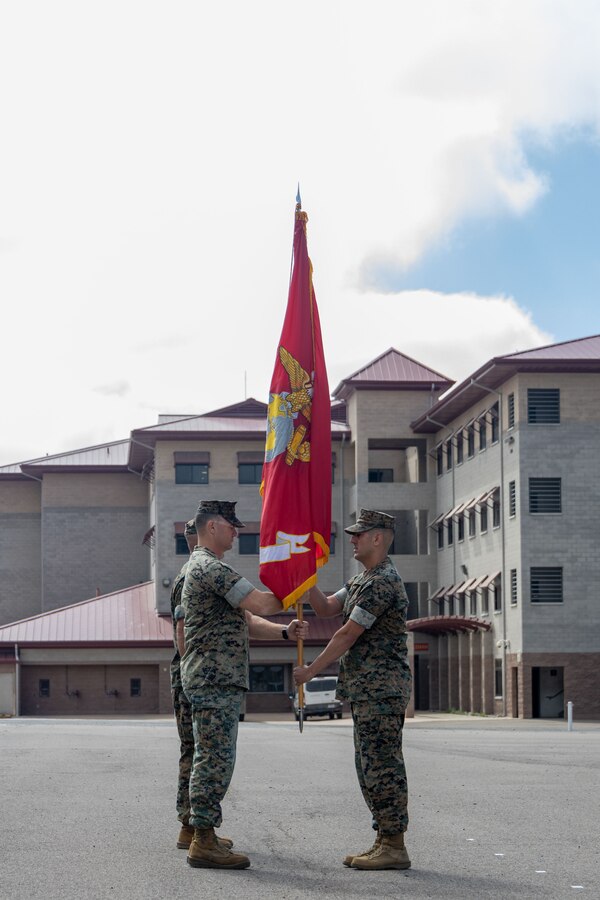 U.S. Marine Corps Sgt. Maj. Miguel Ballate, the sergeant major of Advanced Infantry Training Battalion, School of Infantry – West, delivers the battalion colors to Lt. Col. Thomas Carey, outgoing commanding officer, during a change of command ceremony for AITB, SOI – West on Marine Corps Base Camp Pendleton, California July 7, 2023. AITB, SOI-West, trains, coaches, and qualifies entry-level Marines and Sailors in reconnaissance and advanced infantry skills to fight and win in current and future operating environments. (U.S. Marine Corps photo by Lance Cpl. Mary Jenni)