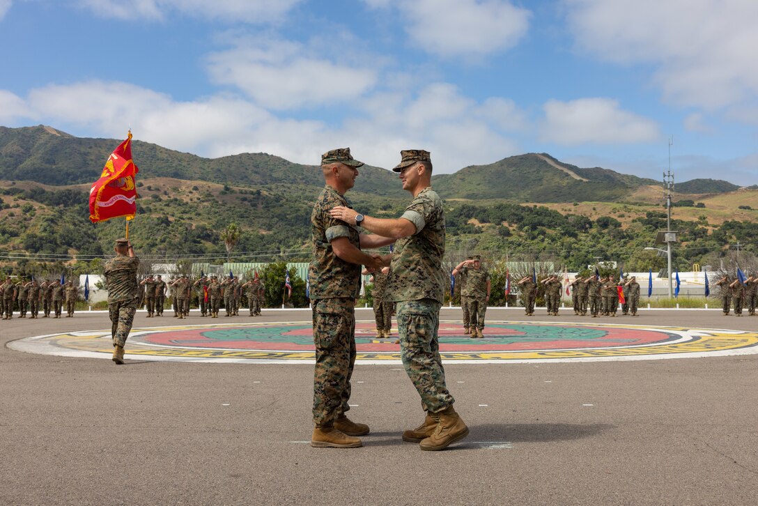U.S. Marine Corps Lt. Col. Thomas Carey, right, the outgoing commanding officer of Advanced Infantry Training Battalion, School of Infantry – West, congratulates Lt. Col. Lonnie Wilson the incoming commanding officer, during a change of command ceremony on Marine Corps Base Camp Pendleton, California, July 7, 2023. AITB, SOI-West, trains, coaches, and qualifies entry-level Marines and Sailors in reconnaissance and advanced infantry skills to fight and win in current and future operating environments. (U.S. Marine Corps photo by Sgt. Andrew Cortez)