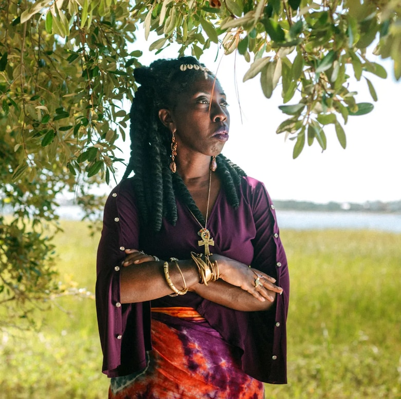 Queen Quet poses for a photo in front of a salt marsh