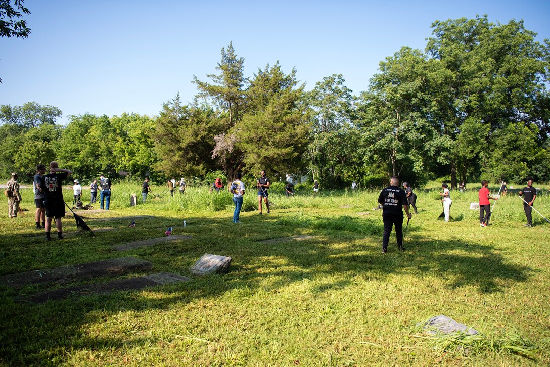 Soldiers from the 128th Aviation Brigade and Soldiers in Advanced Individual Training assigned to Joint Base Langley-Eustis, provide maintenance and restoration to Elmerton and Bassett cemeteries in Hampton, Virginia, July 8, 2023. Fifty-two Soldiers volunteered for the community relations event, part of the Barrett-Peake Heritage Foundation’s restoration project. (U.S. Air Force photo by Abraham Essenmacher)