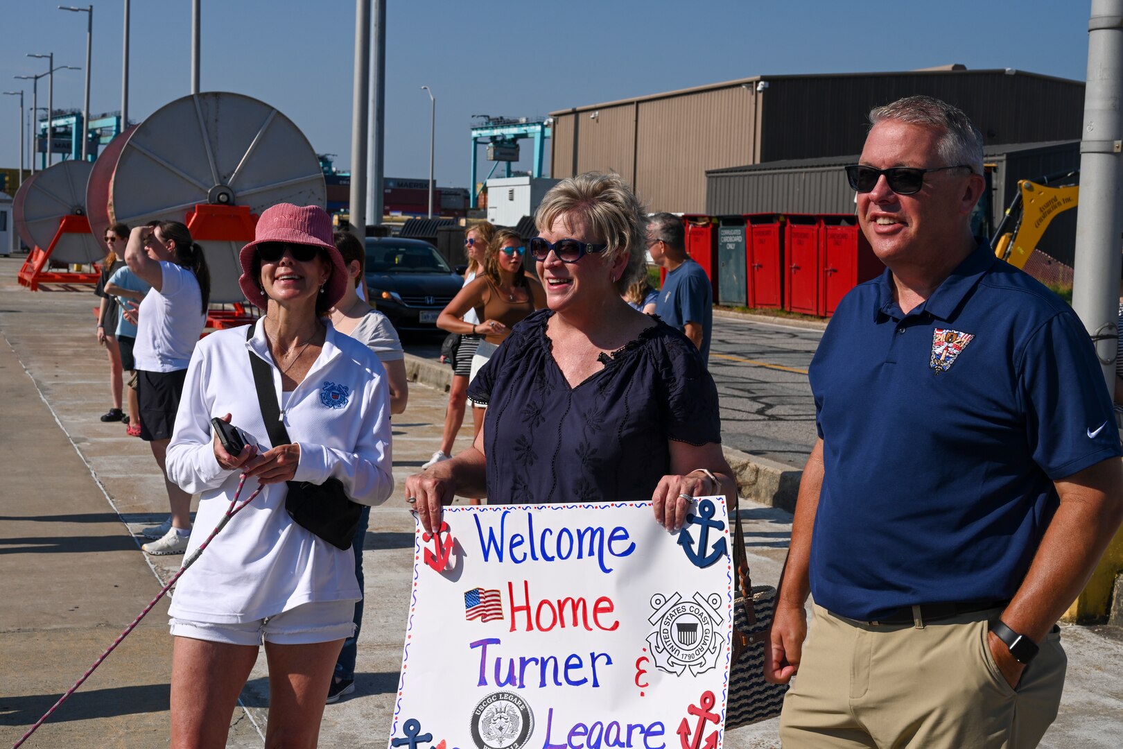 Family members gather to greet the crew of USCGC Legare (WMEC 912) at the unit's return to home port, July 13, 2023, at Coast Guard Base Portsmouth. While underway, Legare’s crew conducted maritime safety and security missions while working to detect, deter and intercept unsafe and illegal maritime migration ventures bound for the United States. (U.S. Coast Guard photo by Petty Officer 3rd Class Kate Kilroy)