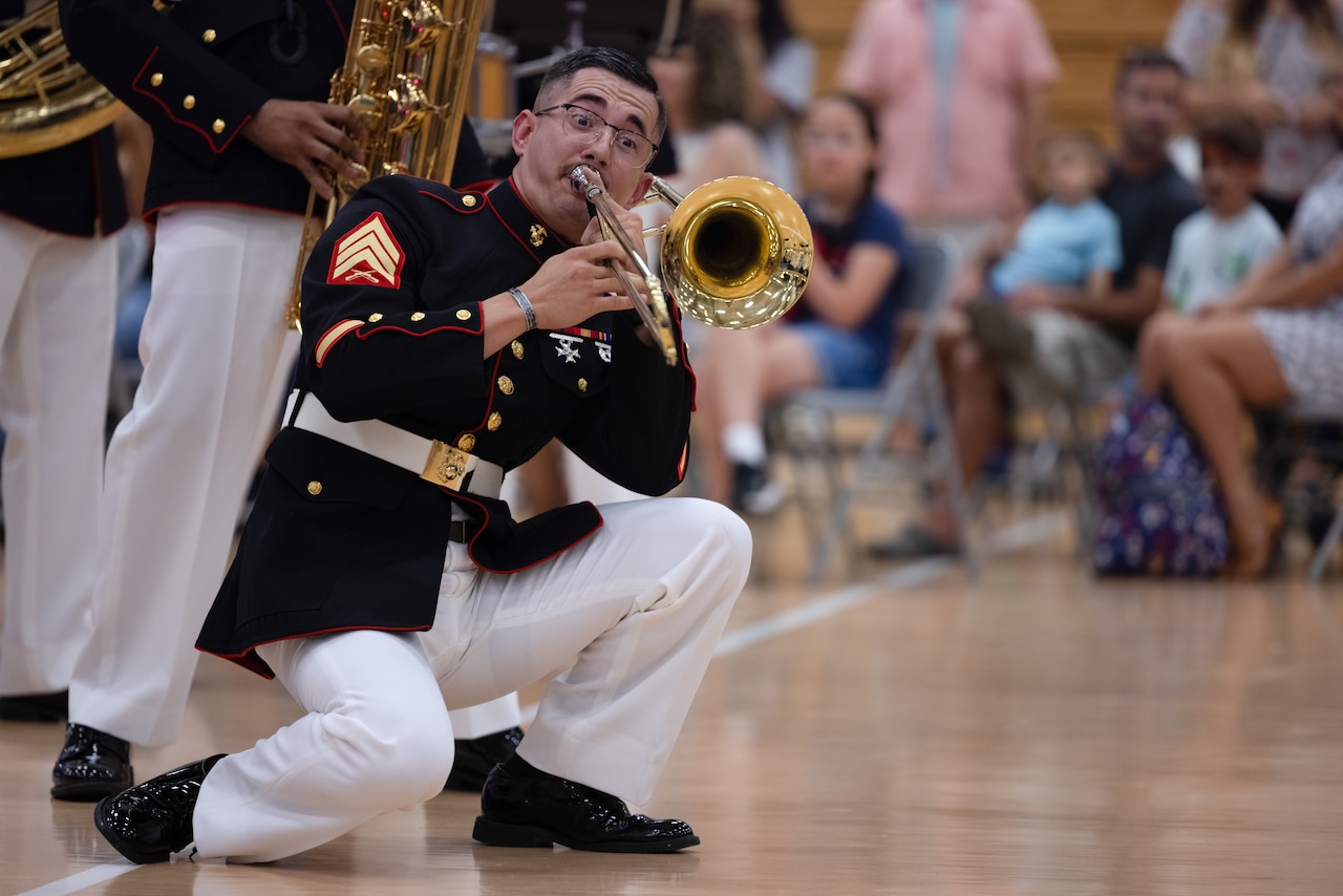 A Marine plays an instrument during a performance.