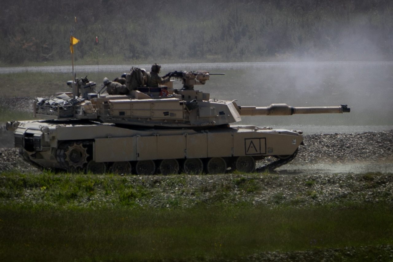 A tanks rolls across terrain.