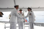 U.S. Coast Guard Cmdr. Karen Kutkiewicz, right, shakes hands with Cmdr. Cory Riesterer, left, at the USCGC Venturous' (WMEC 625) change of command ceremony, July 13, 2023, at Coast Guard Sector St. Petersburg. Capt. Kristen Serumgard, middle, chief of Operational Forces of Coast Guard Atlantic Area, presided over the ceremony. (U.S. Coast Guard photo courtesy of Venturous)