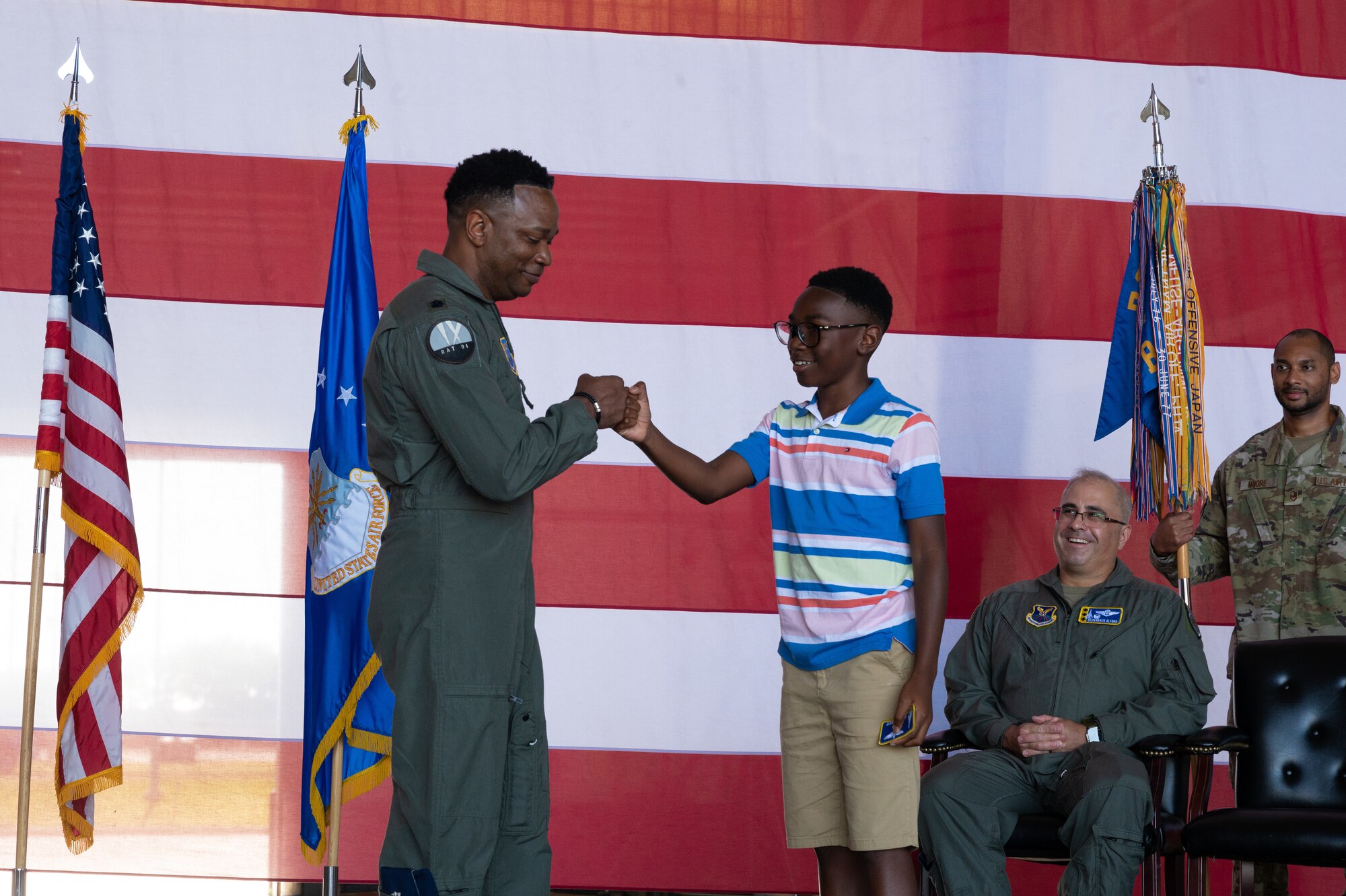 U.S. Air Force Lt. Col. Brian Milner, 9th Bomb Squadron commander, greets his son during the 9th BS change of command at Dyess Air Force Base, Texas, July 7, 2023. Milner is in charge of leading the 9th BS which is the oldest active bomb squadron in the Air Force and maintains combat readiness to ensure delivery of rapid and decisive airpower on a large scale in support of conventional warfare taskings around the world. (U.S. Air Force photo by Airman 1st Class Alondra Cristobal Hernandez)