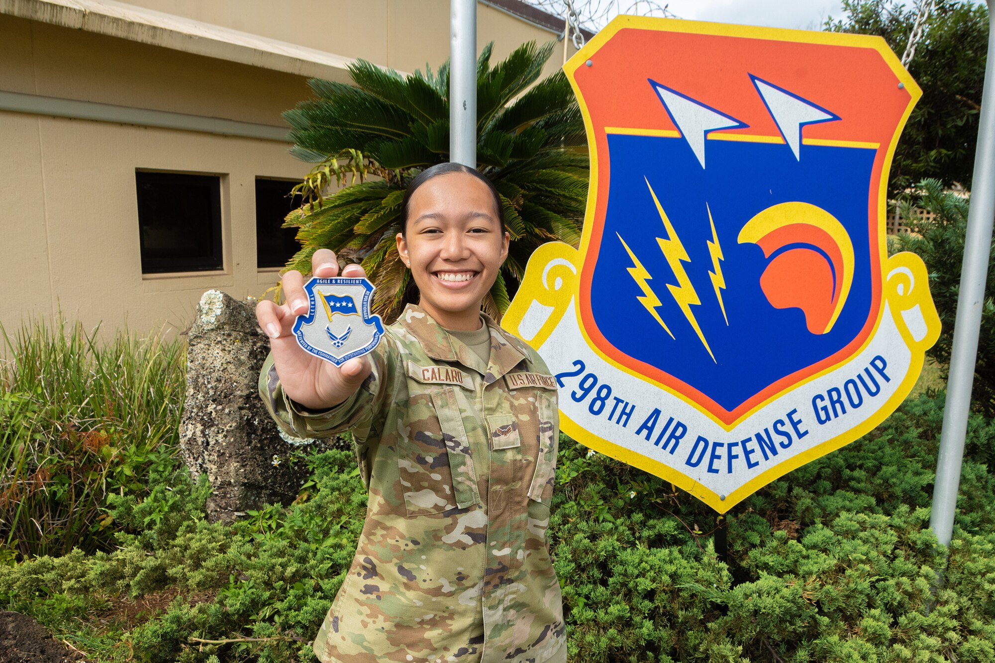 U.S. Air Force Airman 1st Class Faith Calaro, 169th Air Defense Squadron surveillance technician, displays a commander’s coin on June 3, 2023 at Wheeler Army Airfield, Hawaii.
