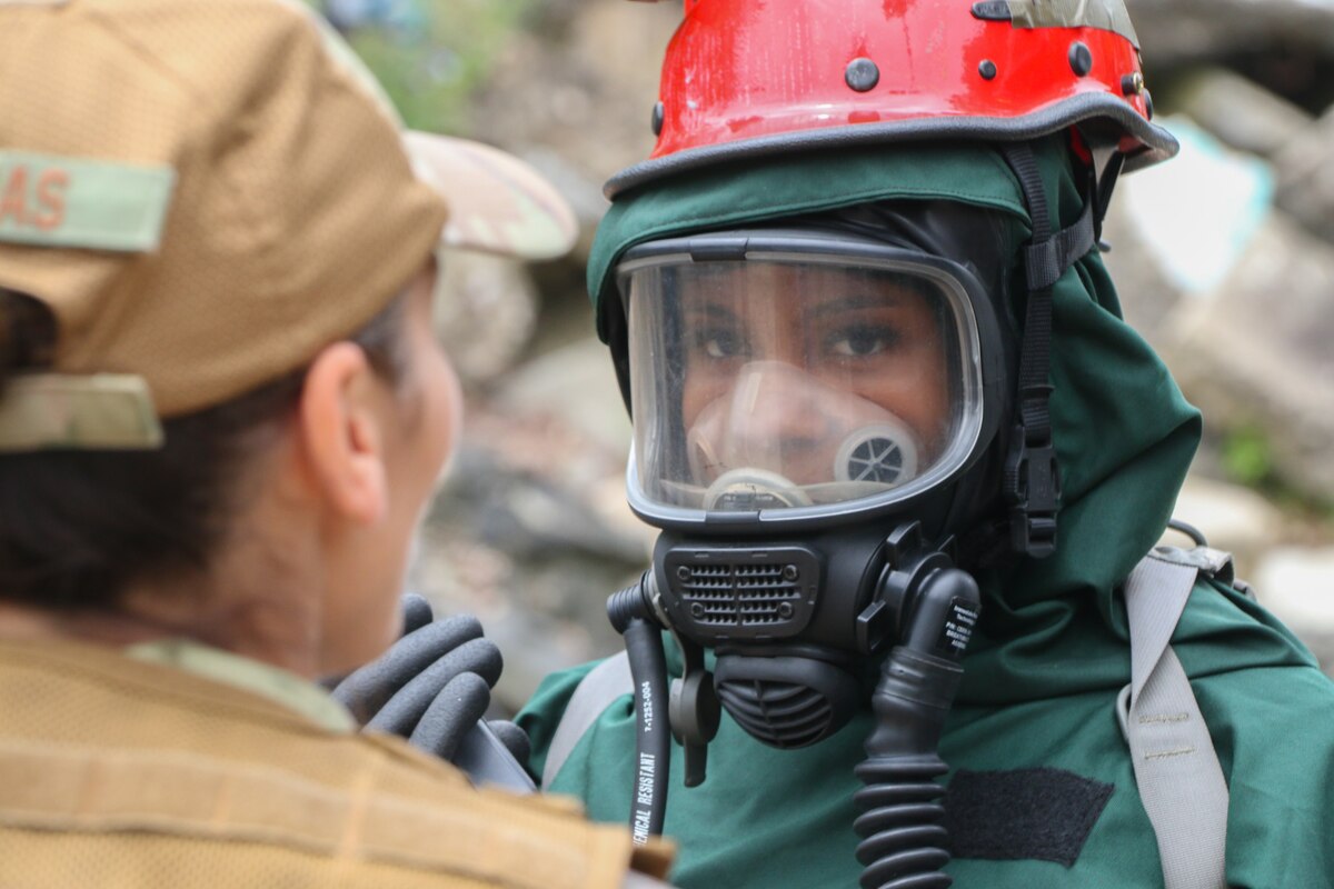 A member of the 113th Force Support Squadron, District of Columbia Air National Guard is accessed wearing a Level C hazmat suit before entering a “hot zone” during a mass casualty and CBRNE response training exercise at Virginia Beach Fire Training Center, May 21, 2023. Eleven members of FSS comprise a nationally certified Fatality Search and Recovery Team (FSRT) responsible for urban search and rescue, mass casualty decontamination, and other federal and state disaster response. (National Guard photo by A.J. Coyne)