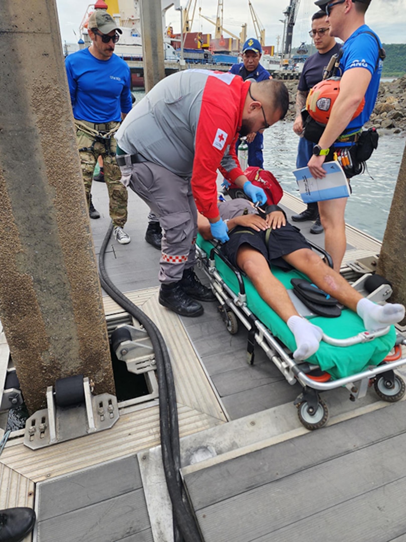 U.S. Air Force pararescuemen with the 131st Rescue Squadron, 129th Rescue Wing, California Air National Guard transfer a patient who sustained a serious head injury on a fishing vessel to the care of Costa Rican paramedics at Puntarenas, Costa Rica, July 11, 2023.