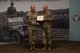 Two men in U.S. Army uniform pose for photo.