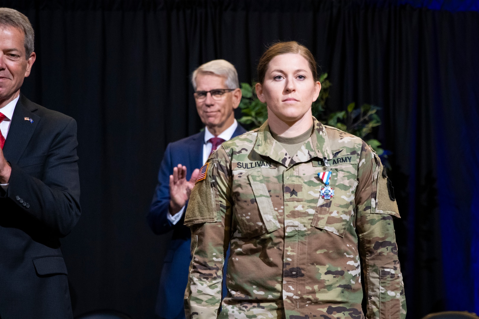 Nebraska Governor Jim Pillen and Maj. Gen. Daryl Bohac, Nebraska adjutant general, present the Nebraska National Guard Heroism Medal to Sgt. Brandi Sullivan during the Nebraska Adjutant General Change of Command Ceremony, July 8, 2023, at the Pinnacle Bank Arena in Lincoln, Nebraska