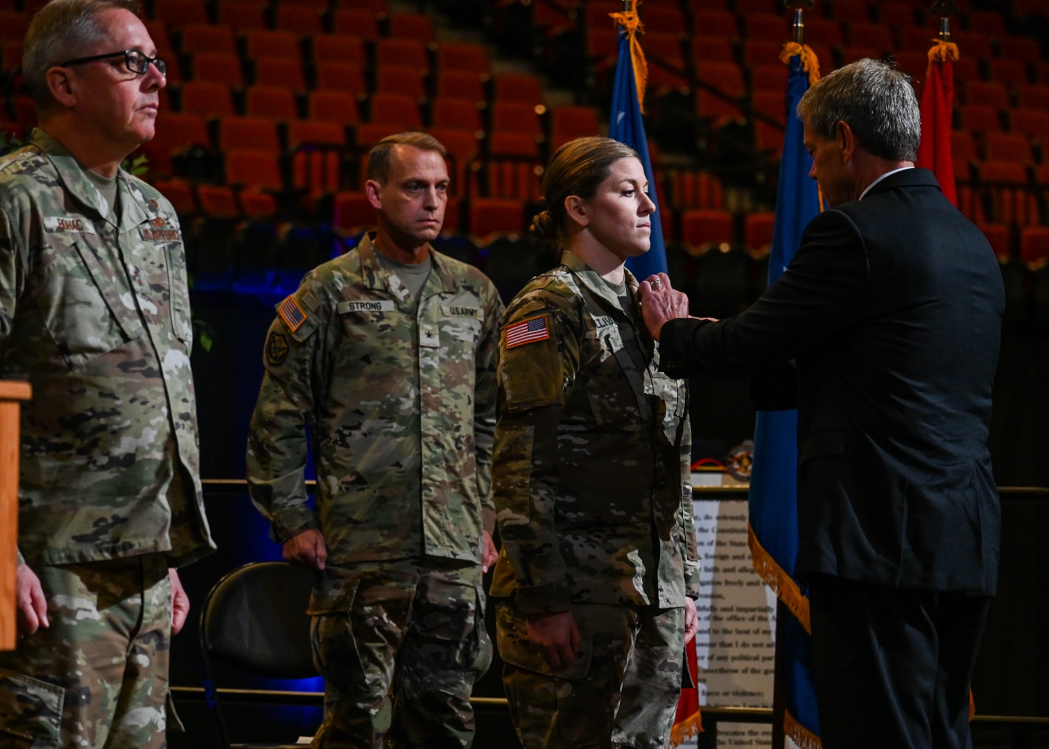 Nebraska Governor Jim Pillen and Maj. Gen. Daryl Bohac, Nebraska adjutant general, present the Nebraska National Guard Heroism Medal to Sgt. Brandi Sullivan during the Nebraska Adjutant General Change of Command Ceremony, July 8, 2023, at the Pinnacle Bank Arena in Lincoln, Nebraska